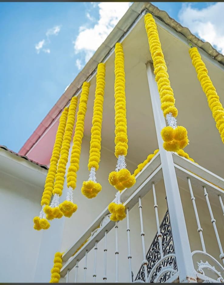 Marigold garlands by Wimcart hung along a balcony